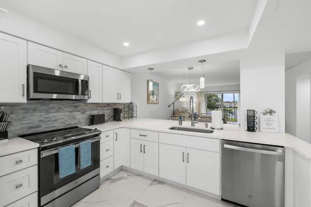a kitchen with a sink stove and microwave