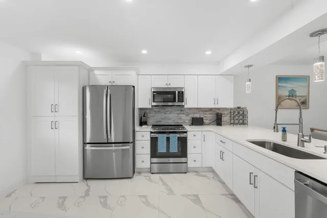 a kitchen with a refrigerator sink and microwave