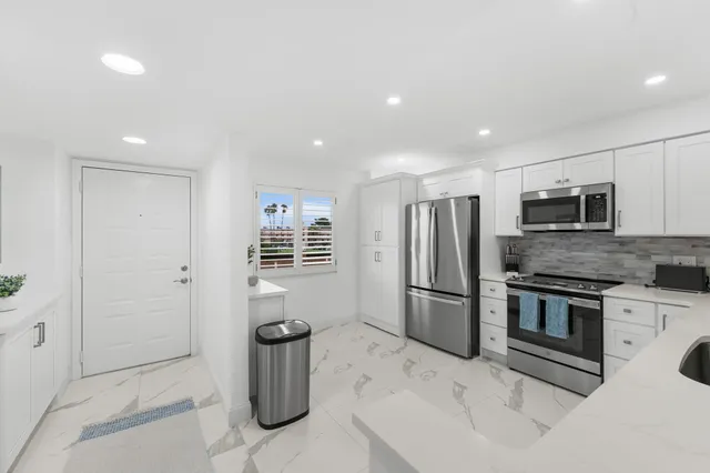 a kitchen with a sink and stainless steel appliances