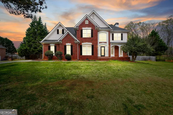 a front view of a house with a yard
