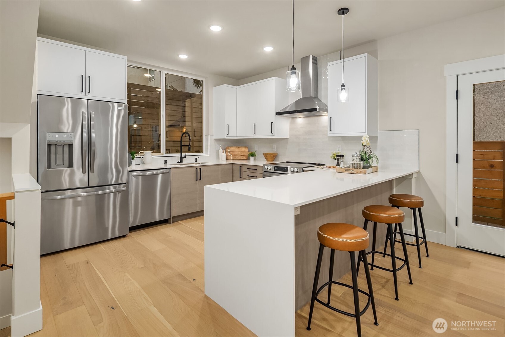1313 14th Avenue South, Unit B Seattle, WA 98144 - Photo 5 of 30 a kitchen with stainless steel appliances a refrigerator a sink a stove a dining table and chairs