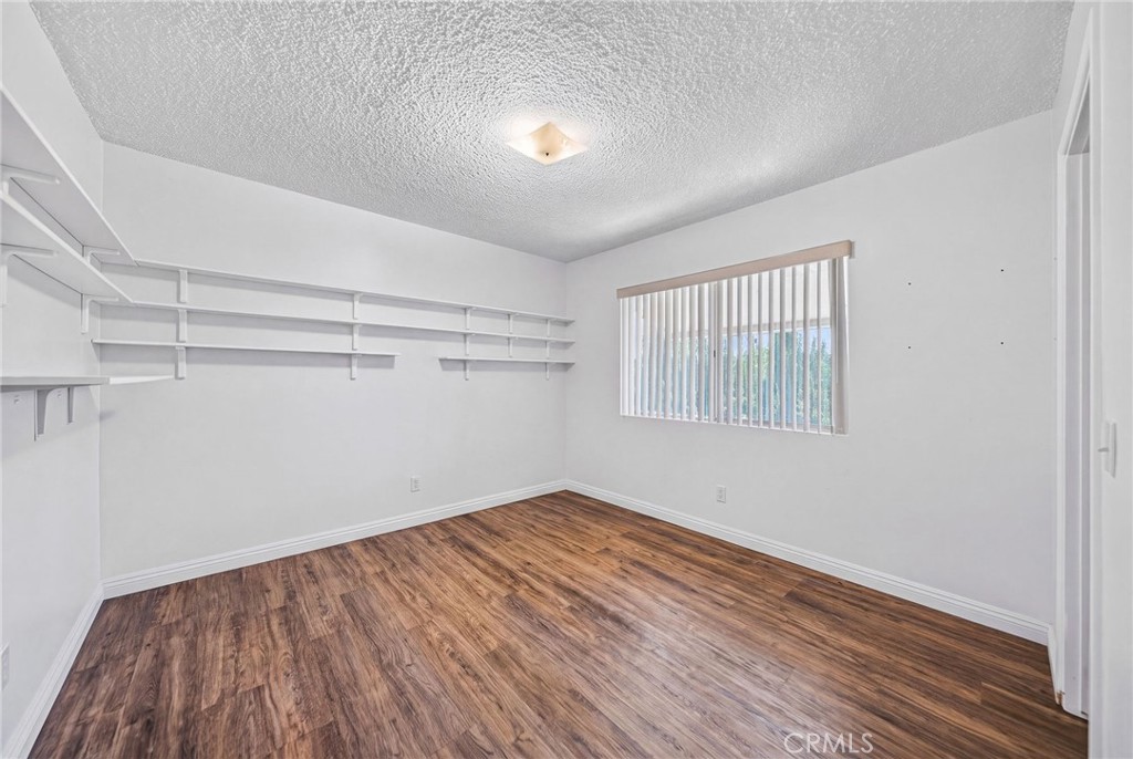 29078 Bradley Road Menifee, CA 92586 - Photo 29 of 42 a view of empty room with wooden floor and fan