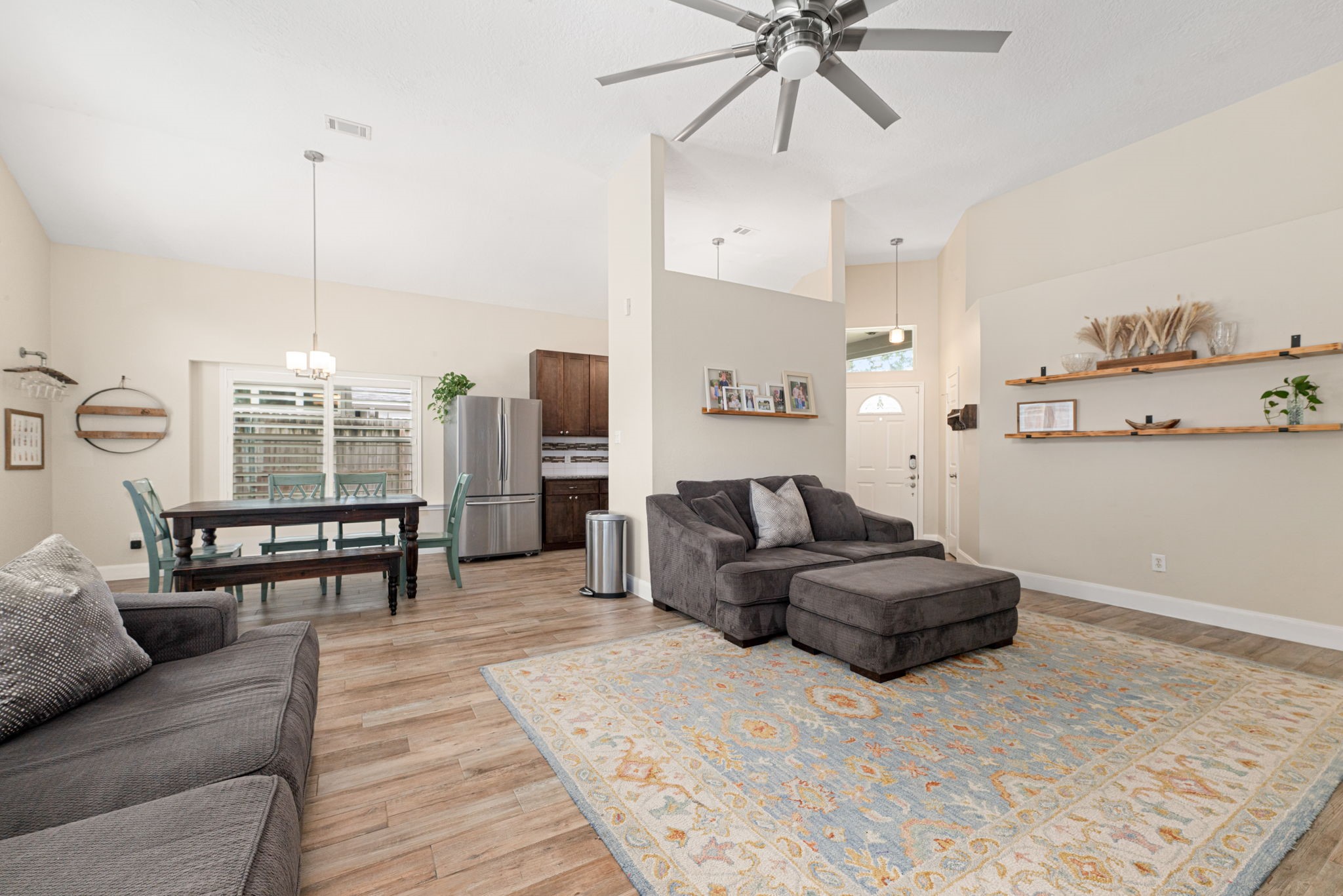 1915 Mercoal Drive Spring, TX 77386 - Photo 9 of 50 Spacious family room featuring high ceilings and an open layout connecting to the dining area.