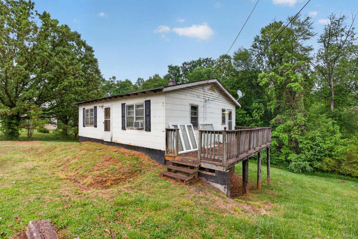 312 Cheney Lane Gretna, VA 24557 - Photo 12 of 16 a view of a house with backyard and a tree