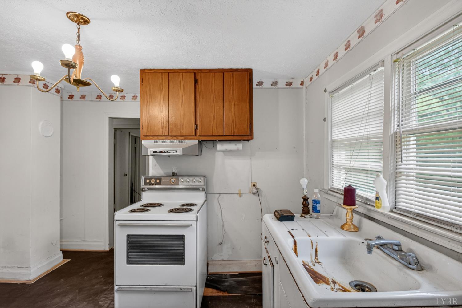312 Cheney Lane Gretna, VA 24557 - Photo 6 of 16 a kitchen with a sink cabinets and window