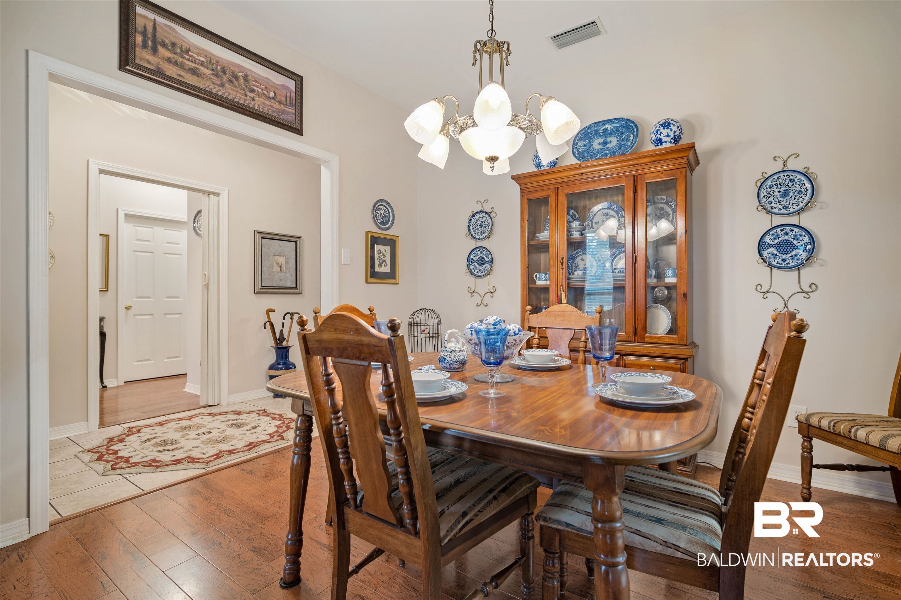 7419 Pake Road Saraland, AL 36571 - Photo 11 of 27 Dining room with wood-type flooring and a notable chandelier