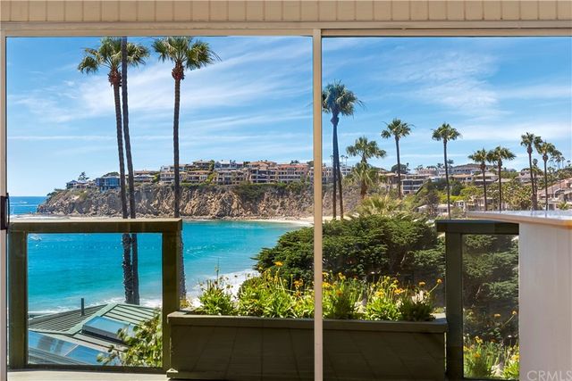 a large white kitchen with a large window