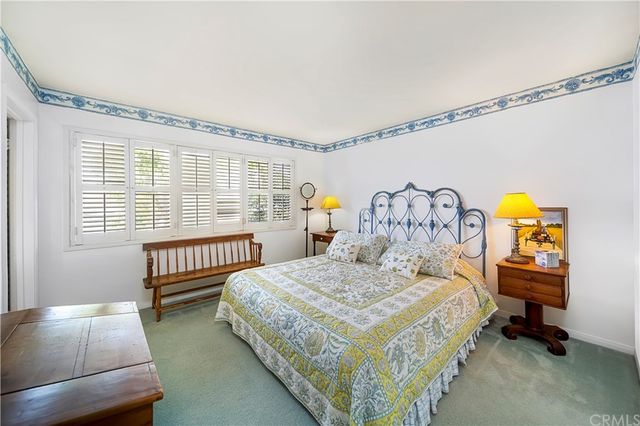 a spacious bedroom with a bed and a large window