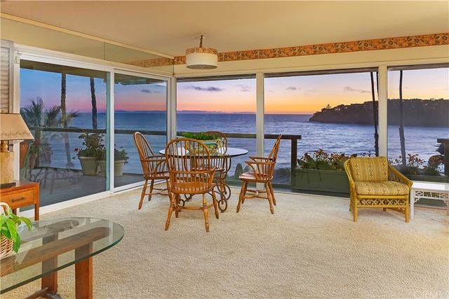 a balcony with table and chairs