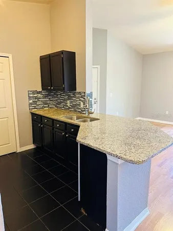 a kitchen with a wooden floor and a fireplace