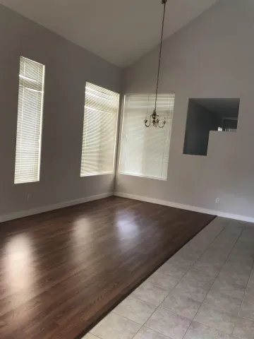 a view of a room with wooden floor and windows