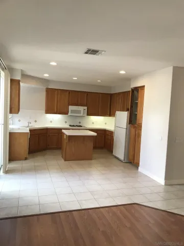 a kitchen with stainless steel appliances a refrigerator sink and cabinets