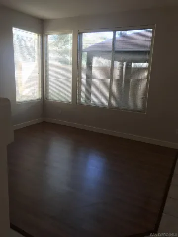 a view of wooden floor and windows in a room