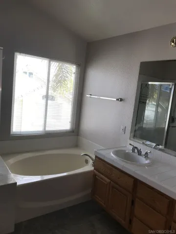 a bathroom with a bathtub and a sink