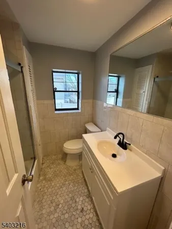 a bathroom with a sink a toilet and mirror