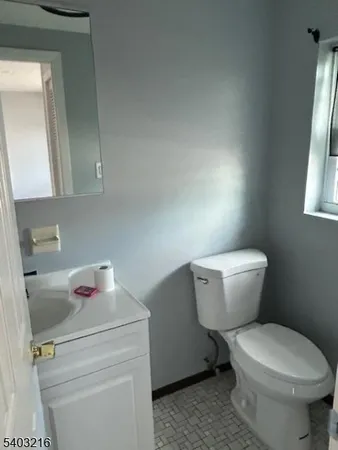 a white toilet sitting next to a bathroom sink
