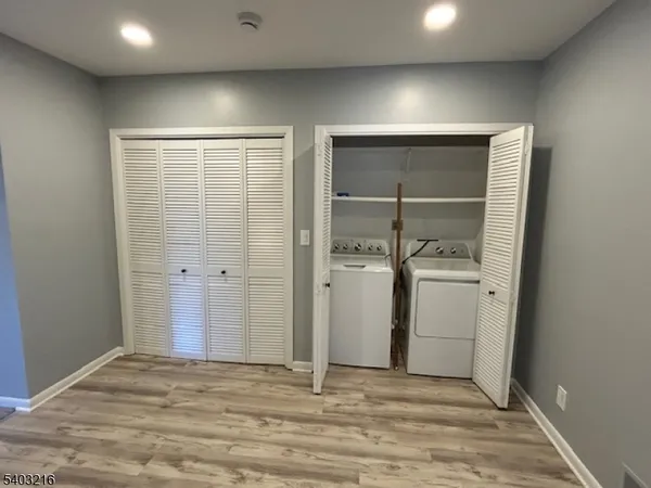 a view of storage and utility room with closet