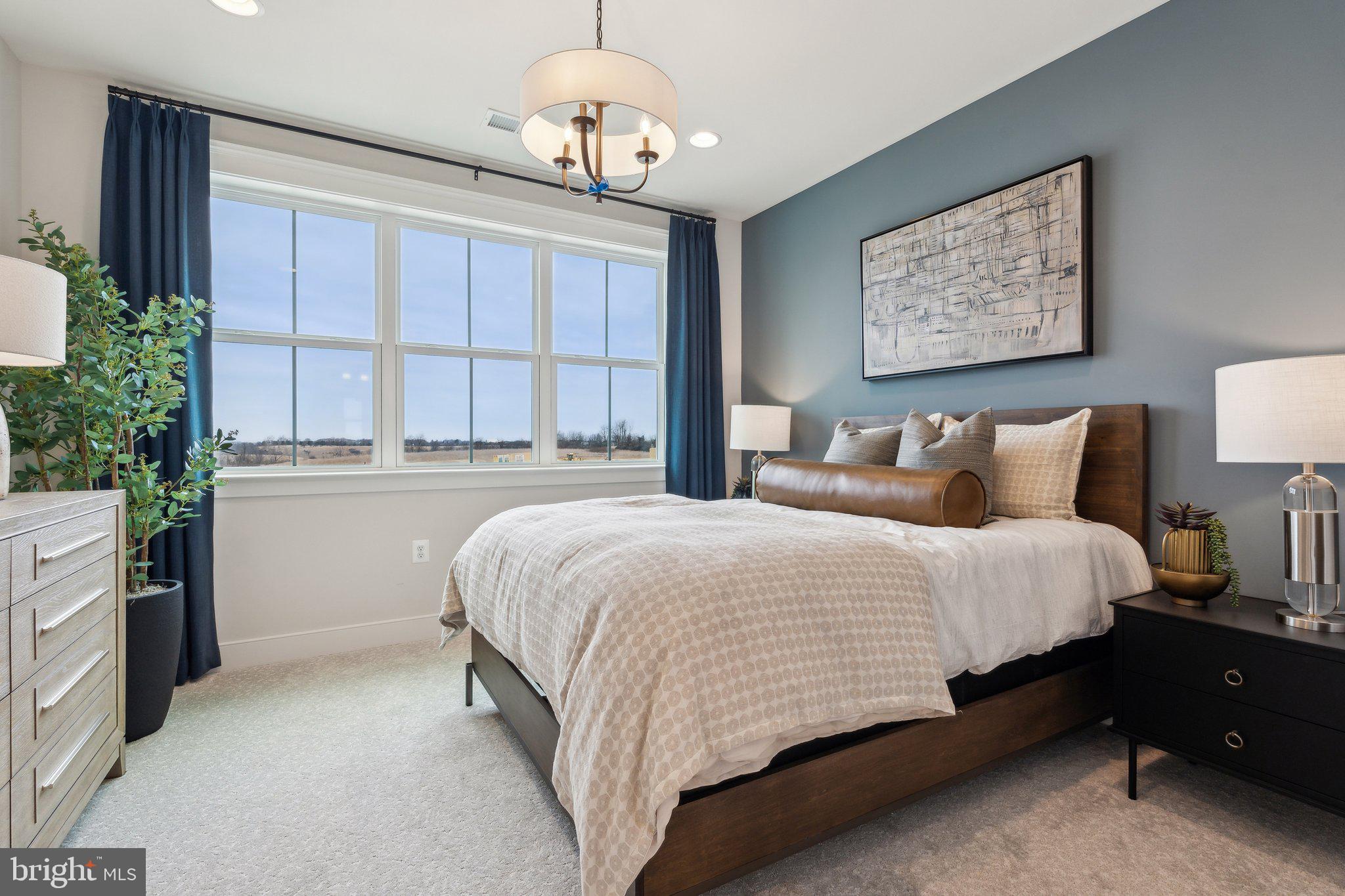 410 Granite Rdg Drive Winchester, VA 22603 - Photo 21 of 27 a spacious bedroom with a bed and a chandelier