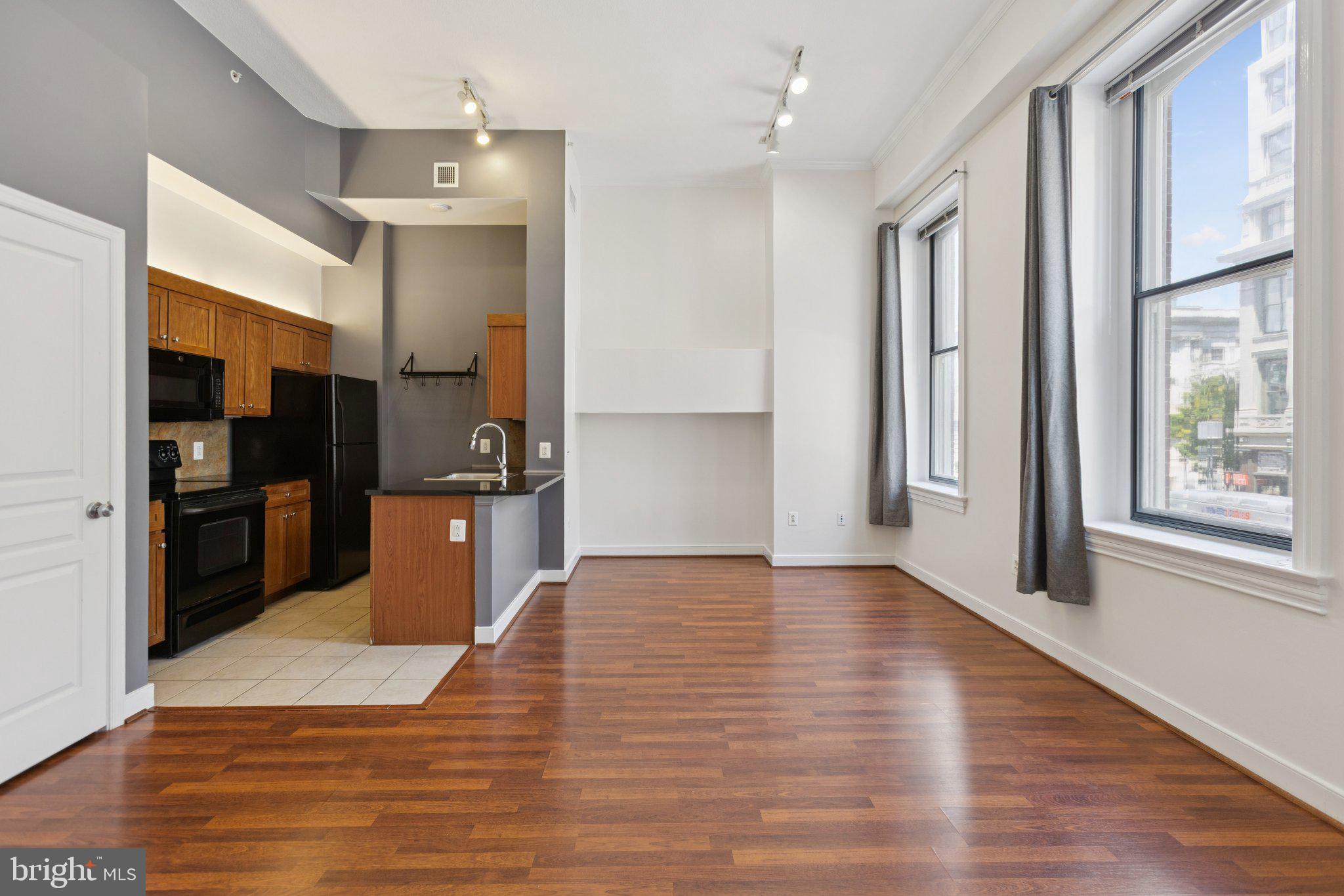 a view of a kitchen cabinets and wooden floor