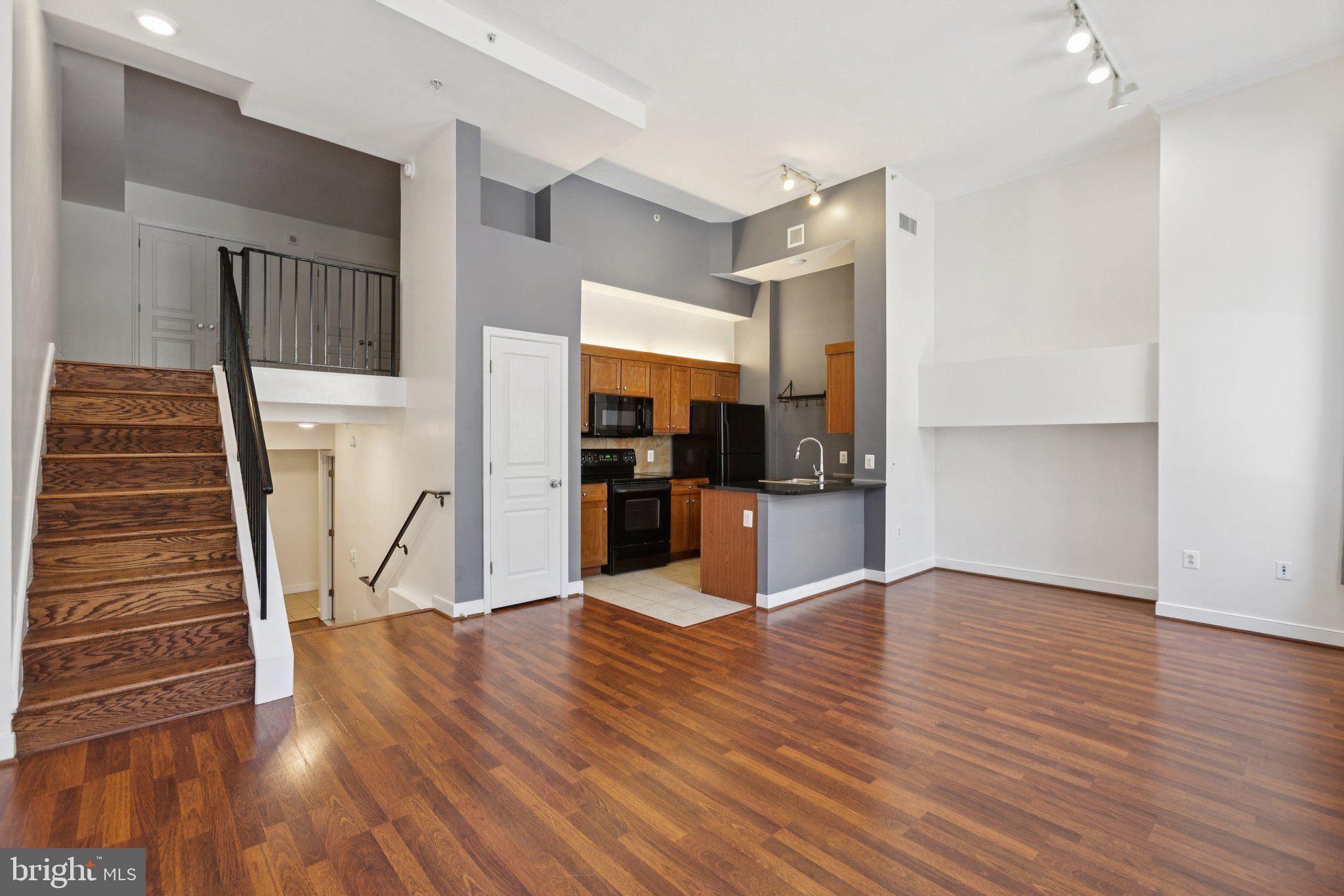 616 E Street Northwest, Unit 217 Washington, DC 20004 - Photo 12 of 73 a view of kitchen with cabinets and wooden floor