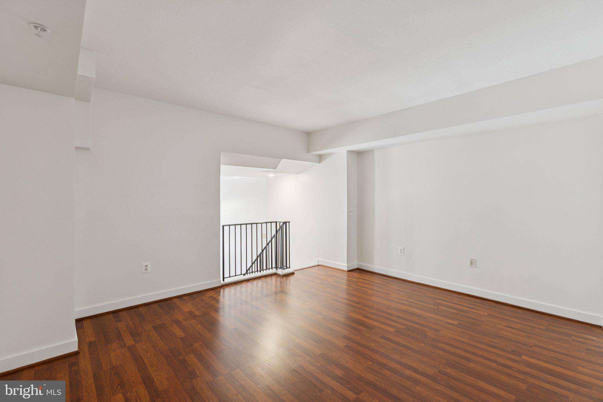 616 E Street Northwest, Unit 217 Washington, DC 20004 - Photo 22 of 73 a view of an empty room with wooden floor