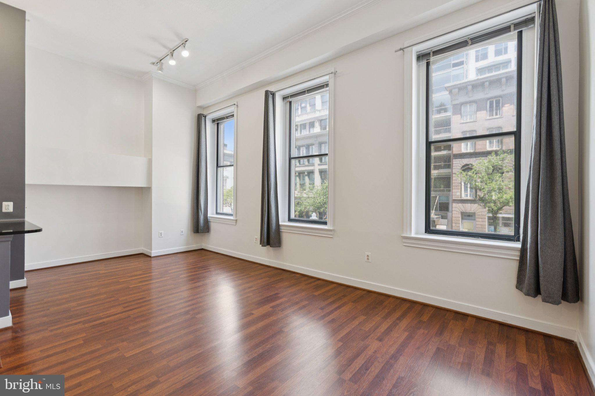 616 E Street Northwest, Unit 217 Washington, DC 20004 - Photo 9 of 73 a view of an empty room with wooden floor and a window