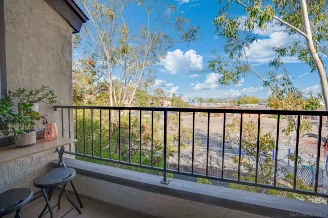 a balcony with table and chairs