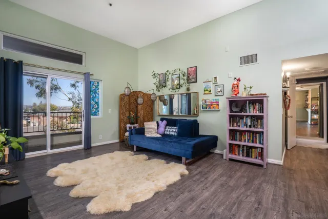 a living room with furniture and a book shelf