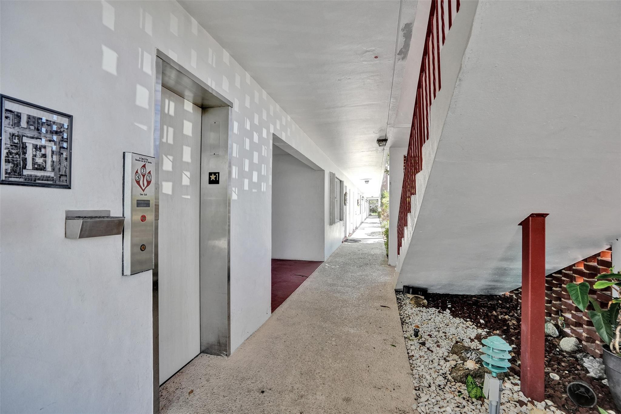 2050 Northeast 39th Street, Unit 203S Lighthouse Point, FL 33064 - Photo 12 of 16 a view of a hallway with wooden floor and entryway