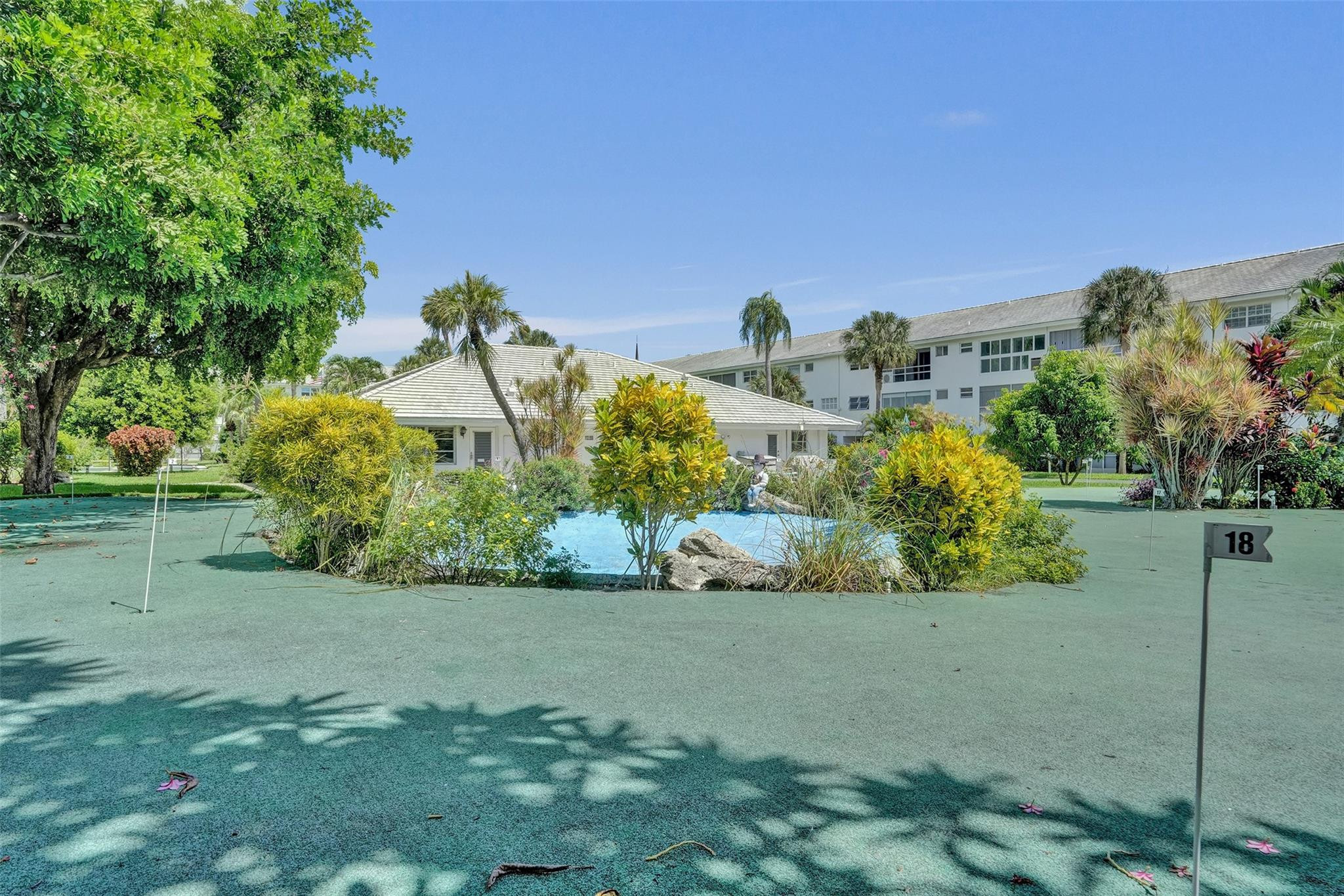 2050 Northeast 39th Street, Unit 203S Lighthouse Point, FL 33064 - Photo 13 of 16 a view of a garden with a building in the background