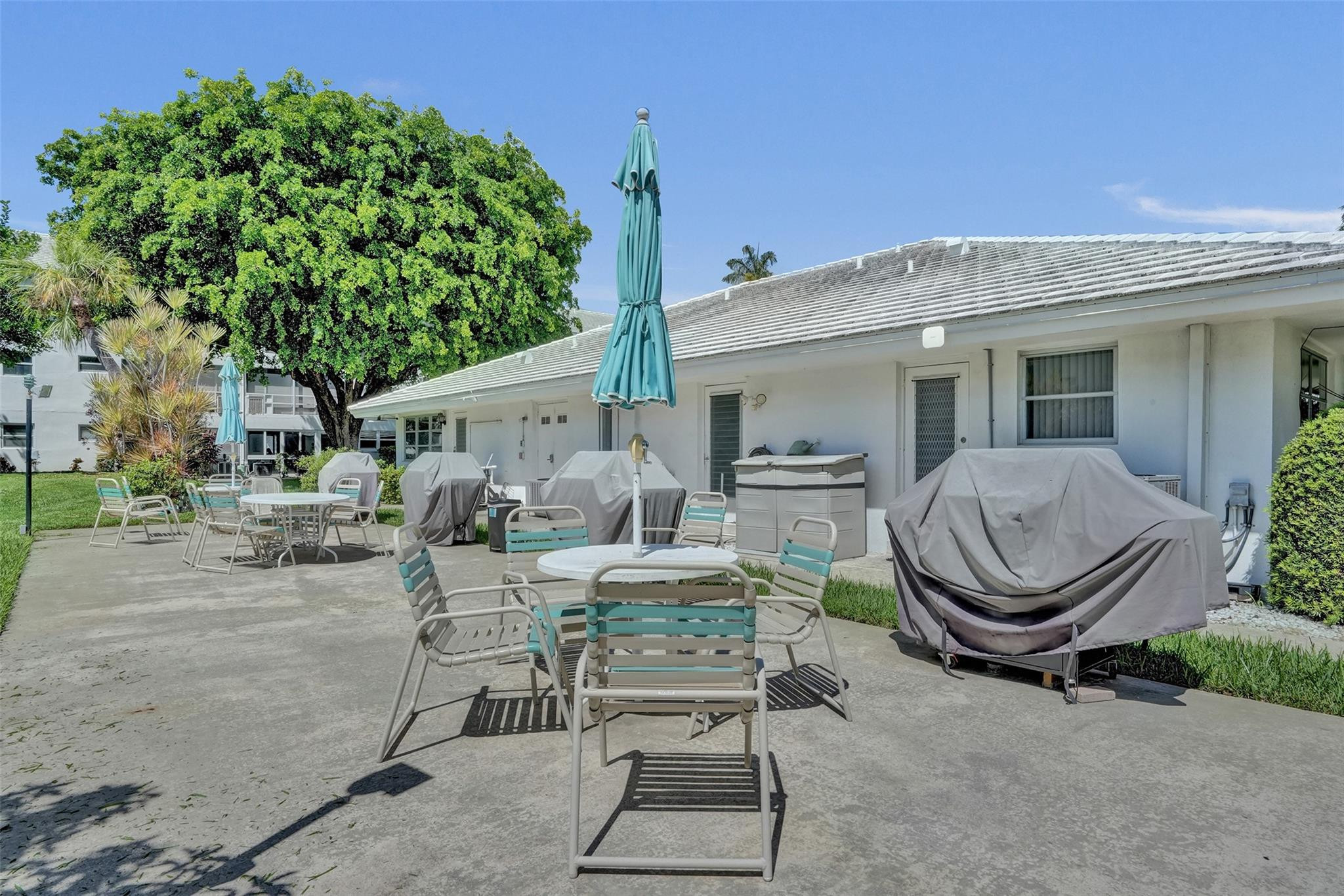 2050 Northeast 39th Street, Unit 203S Lighthouse Point, FL 33064 - Photo 15 of 16 a view of a chair and tables in the patio of the house