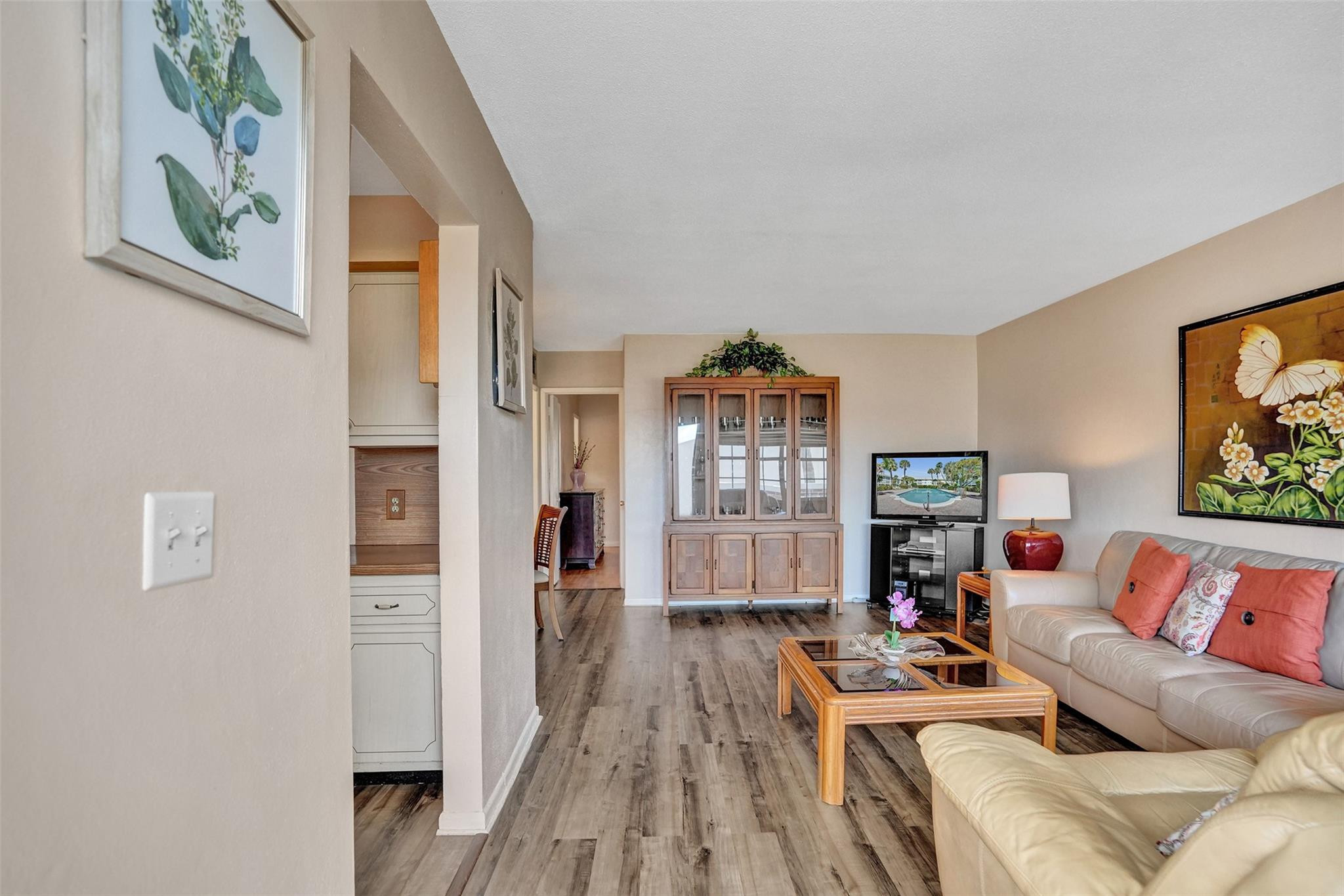 2050 Northeast 39th Street, Unit 203S Lighthouse Point, FL 33064 - Photo 2 of 16 a living room with furniture and a flat screen tv