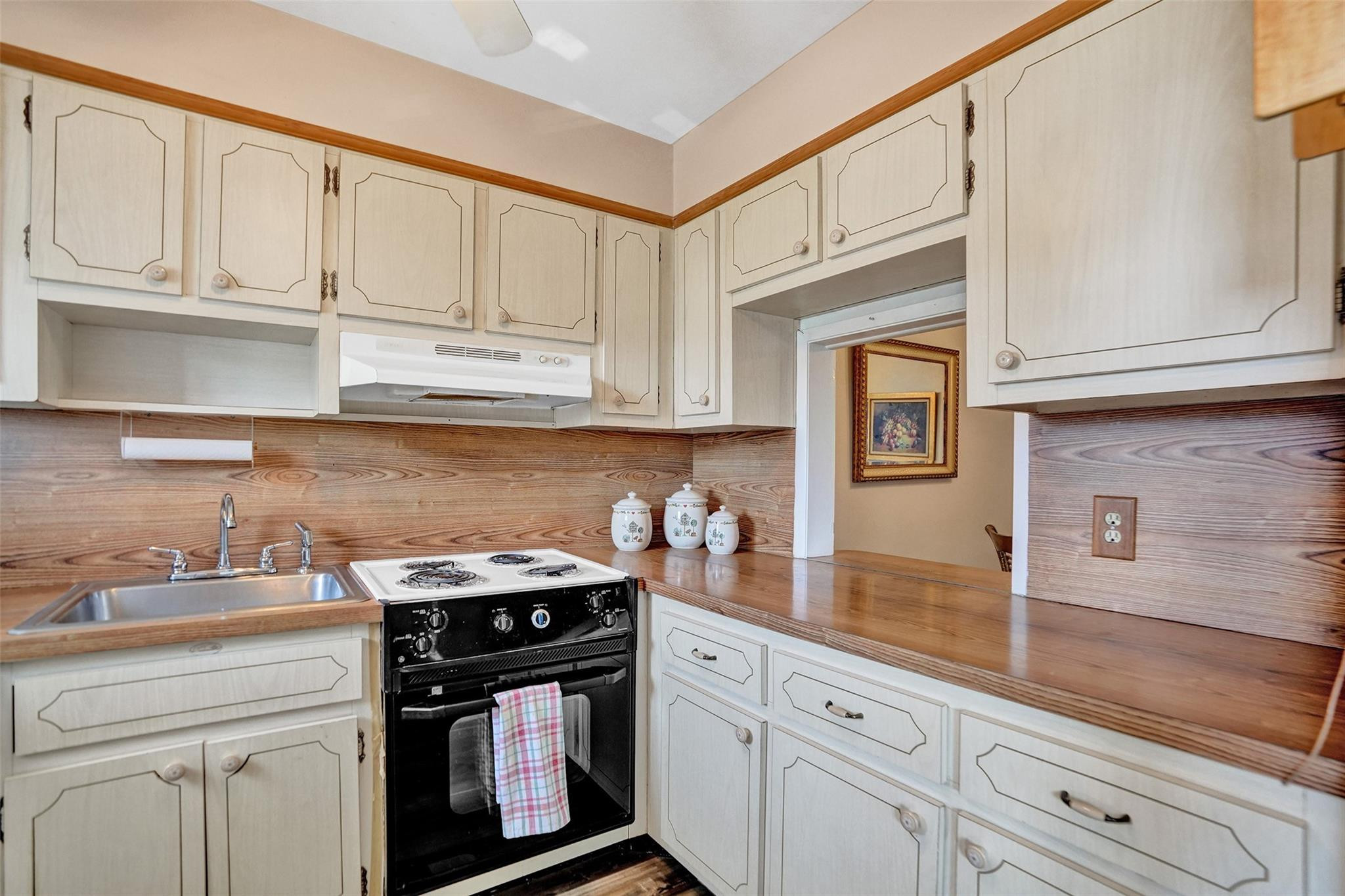 2050 Northeast 39th Street, Unit 203S Lighthouse Point, FL 33064 - Photo 3 of 16 a kitchen with granite countertop white cabinets and a stove