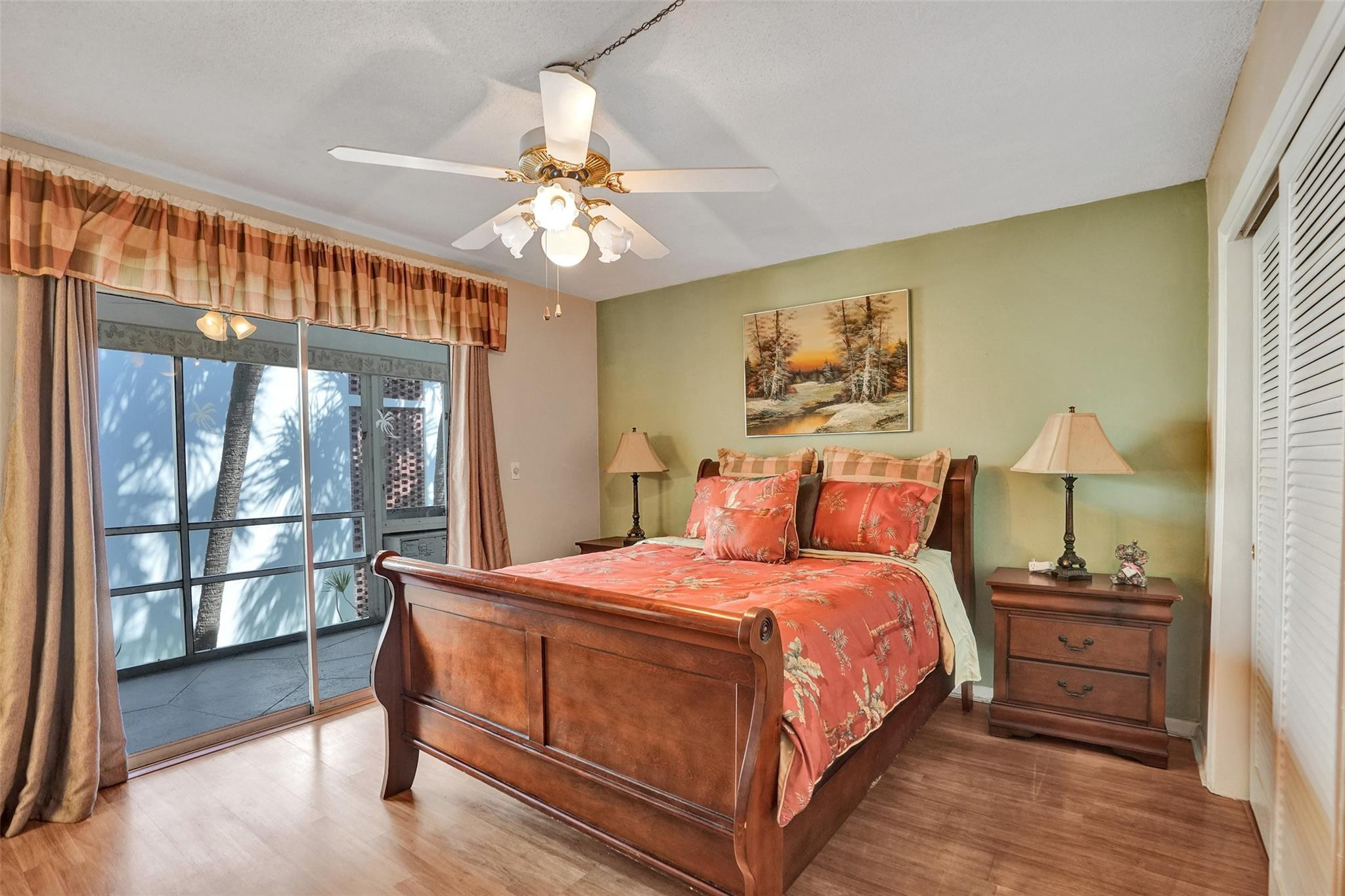 2050 Northeast 39th Street, Unit 203S Lighthouse Point, FL 33064 - Photo 6 of 16 a bedroom with a large bed and a chandelier