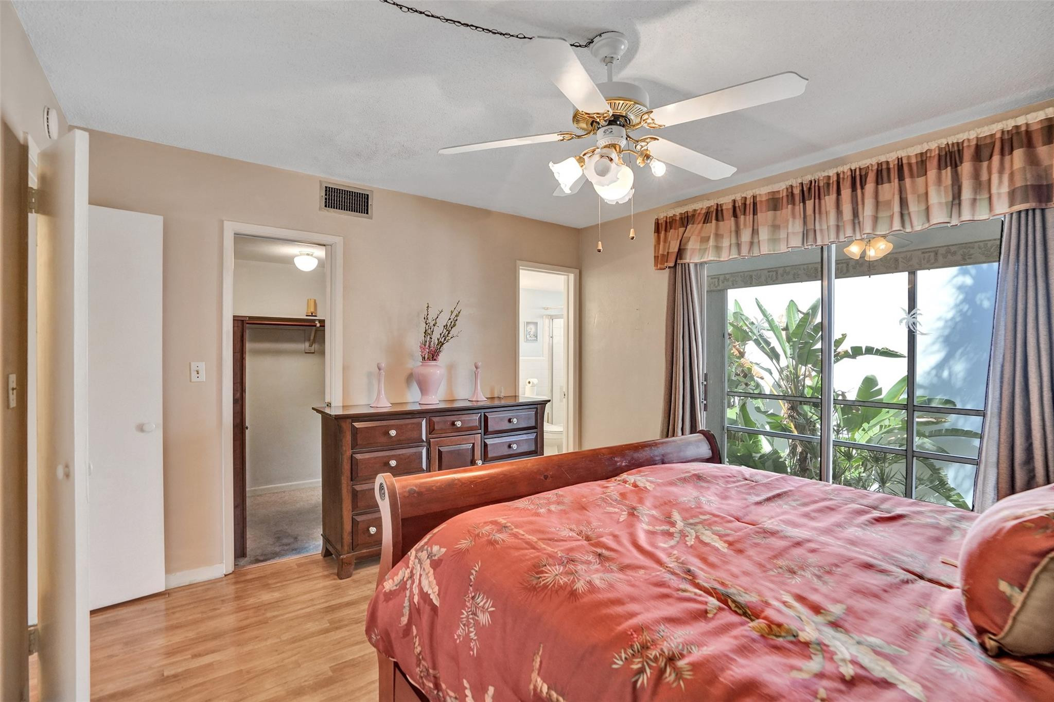 2050 Northeast 39th Street, Unit 203S Lighthouse Point, FL 33064 - Photo 7 of 16 a bedroom with a large bed and a chandelier