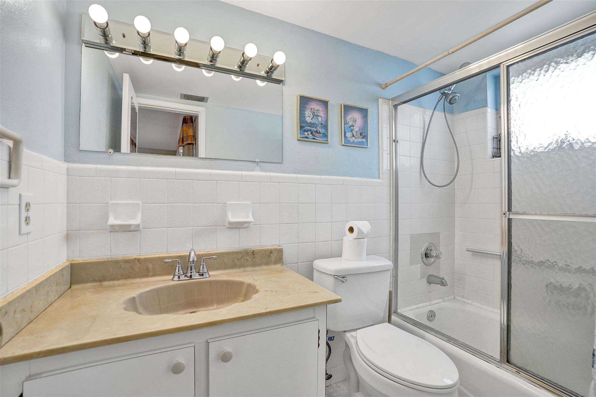 2050 Northeast 39th Street, Unit 203S Lighthouse Point, FL 33064 - Photo 8 of 16 a bathroom with a sink toilet mirror and shower