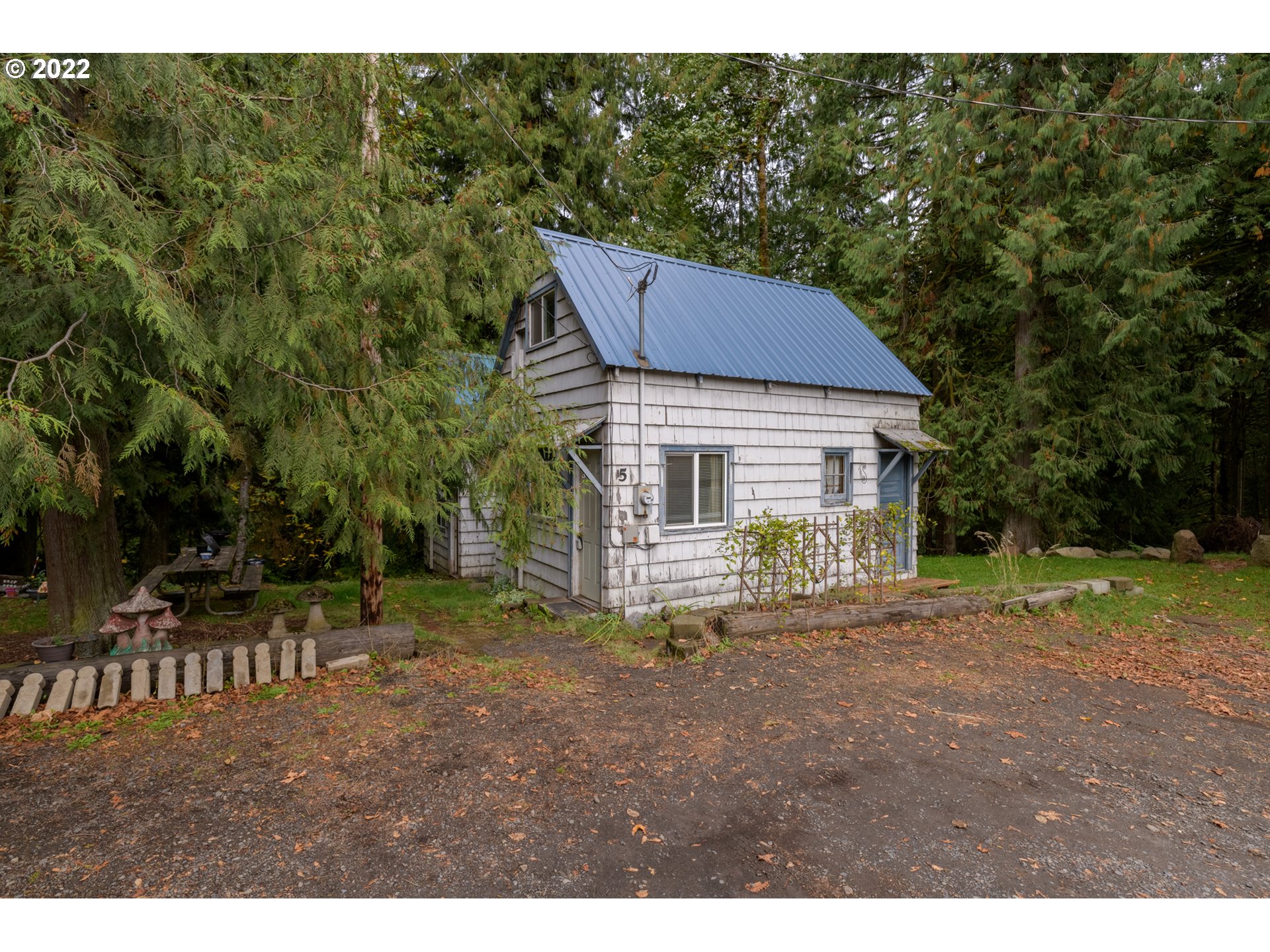 69947 East E Highway, Unit 5 Rhododendron, OR 97049 - Photo 5 of 31 a backyard of a house with table and chairs