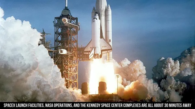 a view of a living room with kitchen and a wooden floor