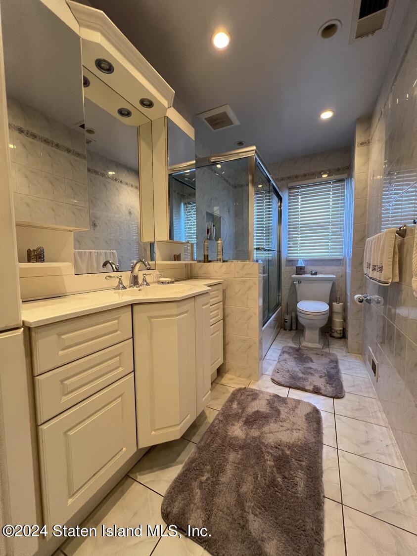 28 Gary Place Staten Island, NY 10314 - Photo 11 of 28 a room with a sink and white cabinets