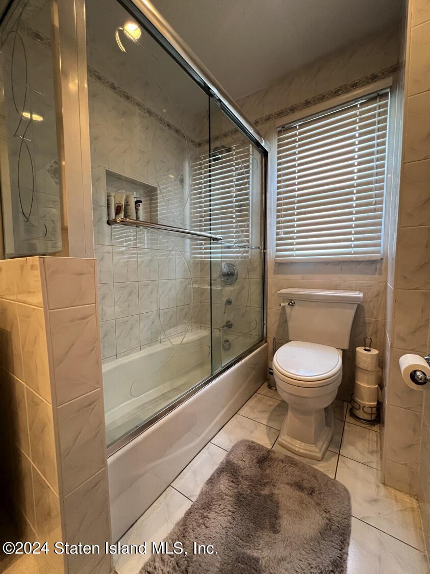 28 Gary Place Staten Island, NY 10314 - Photo 12 of 28 a bathroom with a toilet and a shower