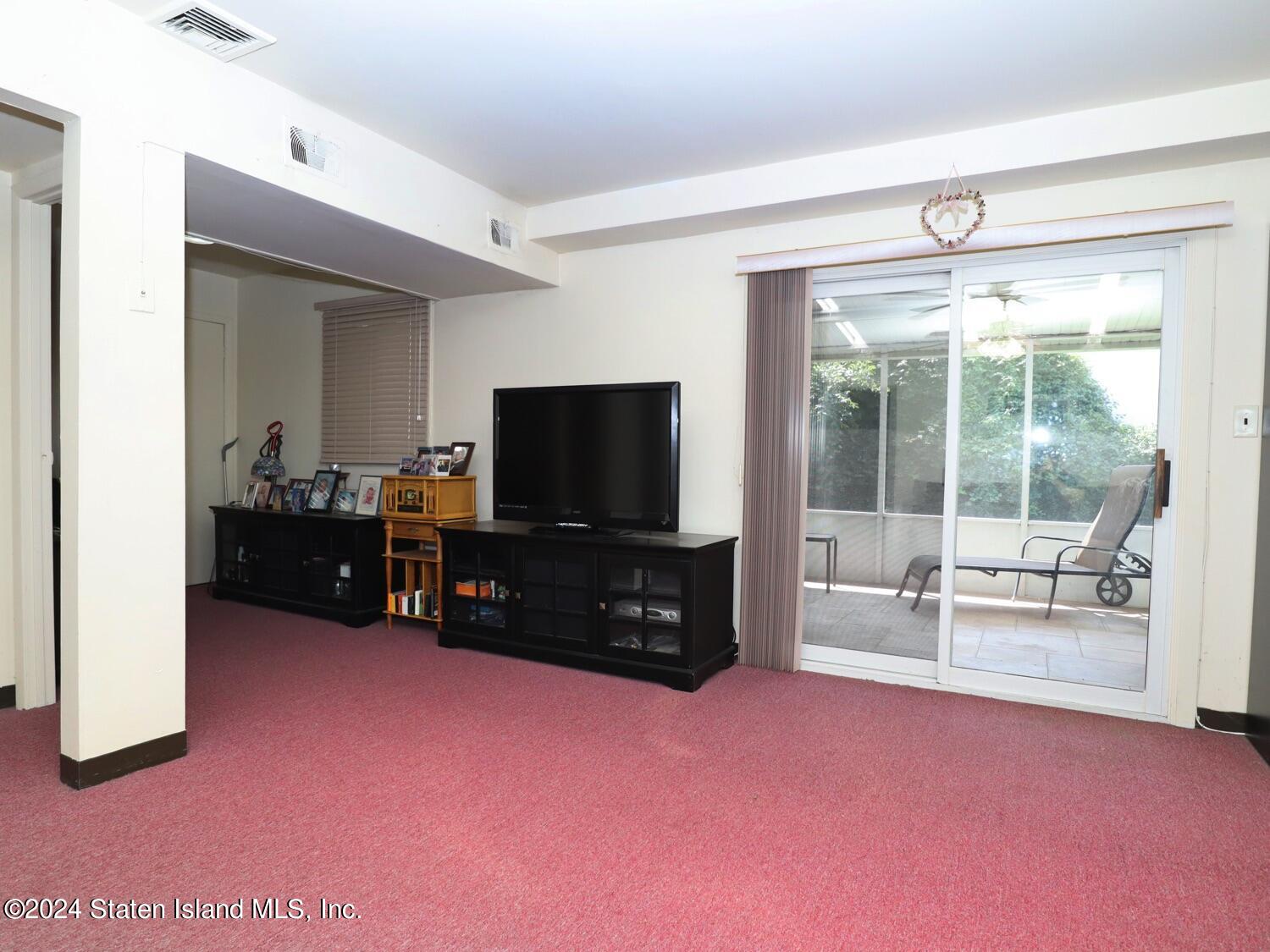 28 Gary Place Staten Island, NY 10314 - Photo 14 of 28 a living room with furniture and a flat screen tv