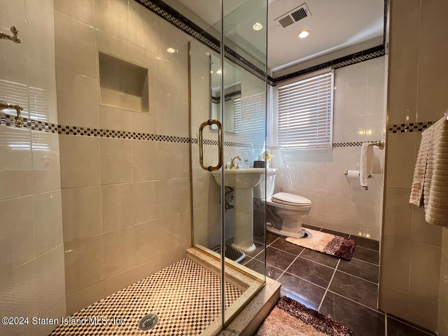28 Gary Place Staten Island, NY 10314 - Photo 15 of 28 a bathroom with a sink toilet and shower