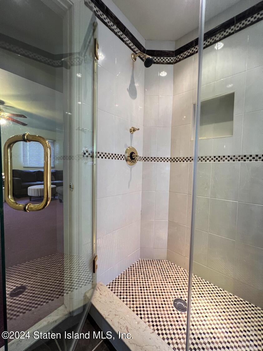 28 Gary Place Staten Island, NY 10314 - Photo 17 of 28 a bathroom with a glass shower door