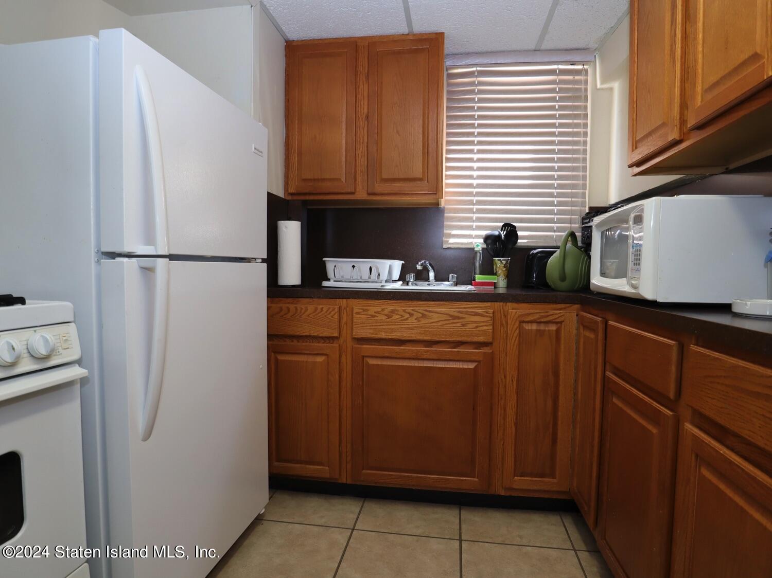 28 Gary Place Staten Island, NY 10314 - Photo 19 of 28 a kitchen with stainless steel appliances a refrigerator sink and cabinets