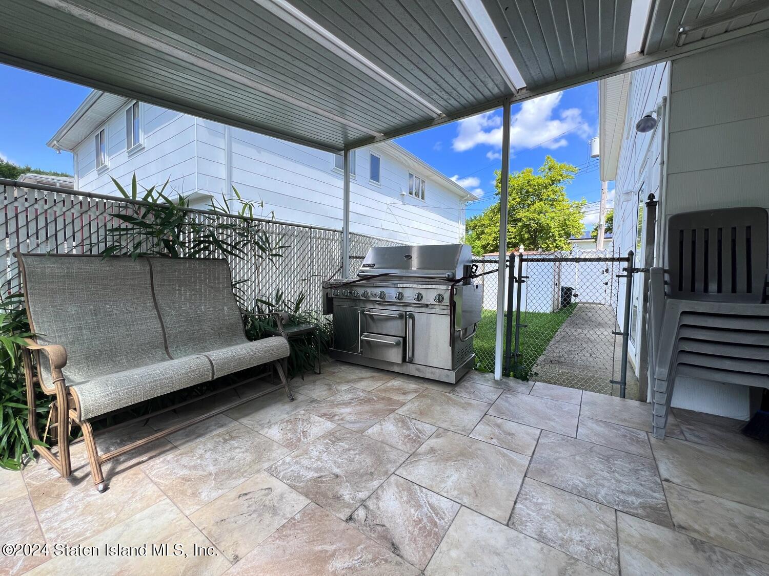 28 Gary Place Staten Island, NY 10314 - Photo 21 of 28 a view of a patio with table and chairs potted plants