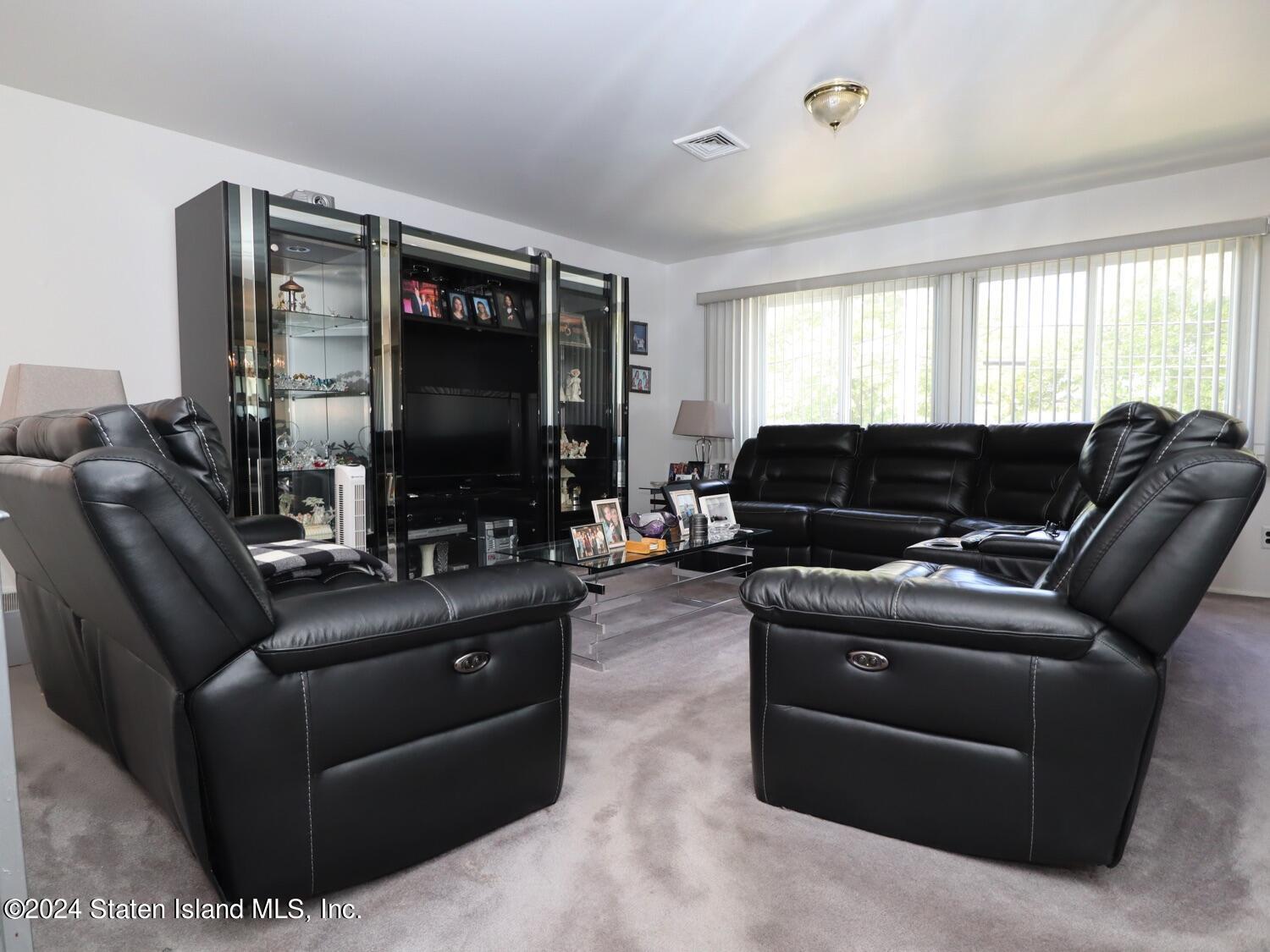 28 Gary Place Staten Island, NY 10314 - Photo 4 of 28 a living room with furniture a flat screen tv and a window