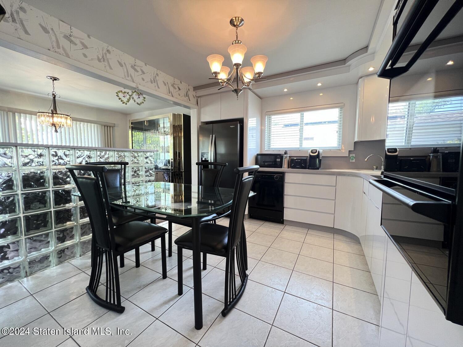 28 Gary Place Staten Island, NY 10314 - Photo 5 of 28 a view of a dining room with furniture and chandelier