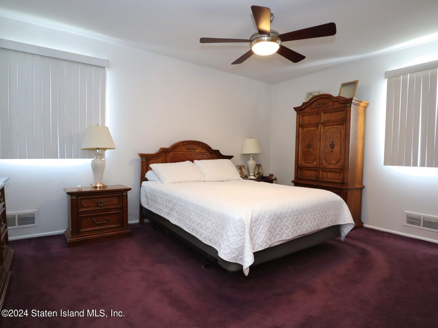 28 Gary Place Staten Island, NY 10314 - Photo 8 of 28 a bedroom with a bed and a chandelier