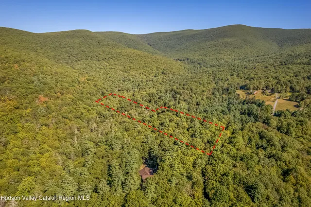 a view of a lush green hillside and a building