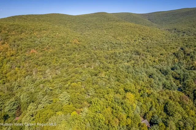 a view of a large mountain with an ocean